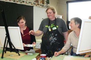Instructor Katie Ohlke demonstrates a technique to Sarah and Donna Wood at the North Addington Education Centre’s art night last Friday in Cloyne. Photo/Craig Bakay